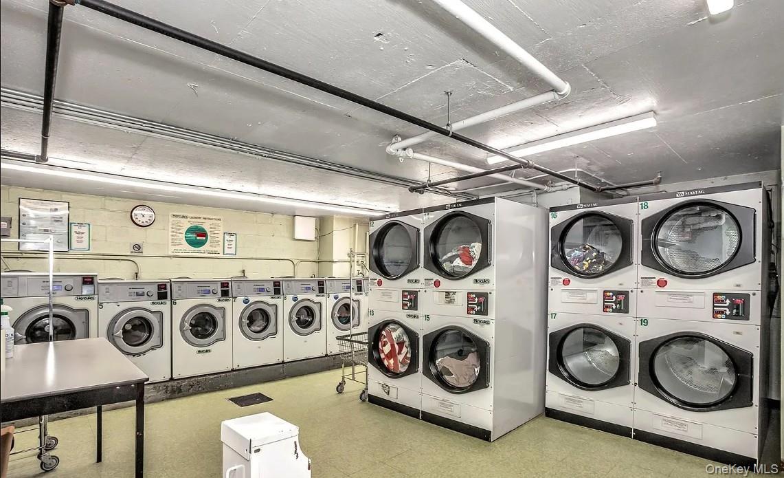 118-18 Union Turnpike, Unit 16A Queens, NY 11415 - Photo 12 of 13 a utility room with a stove and cabinets
