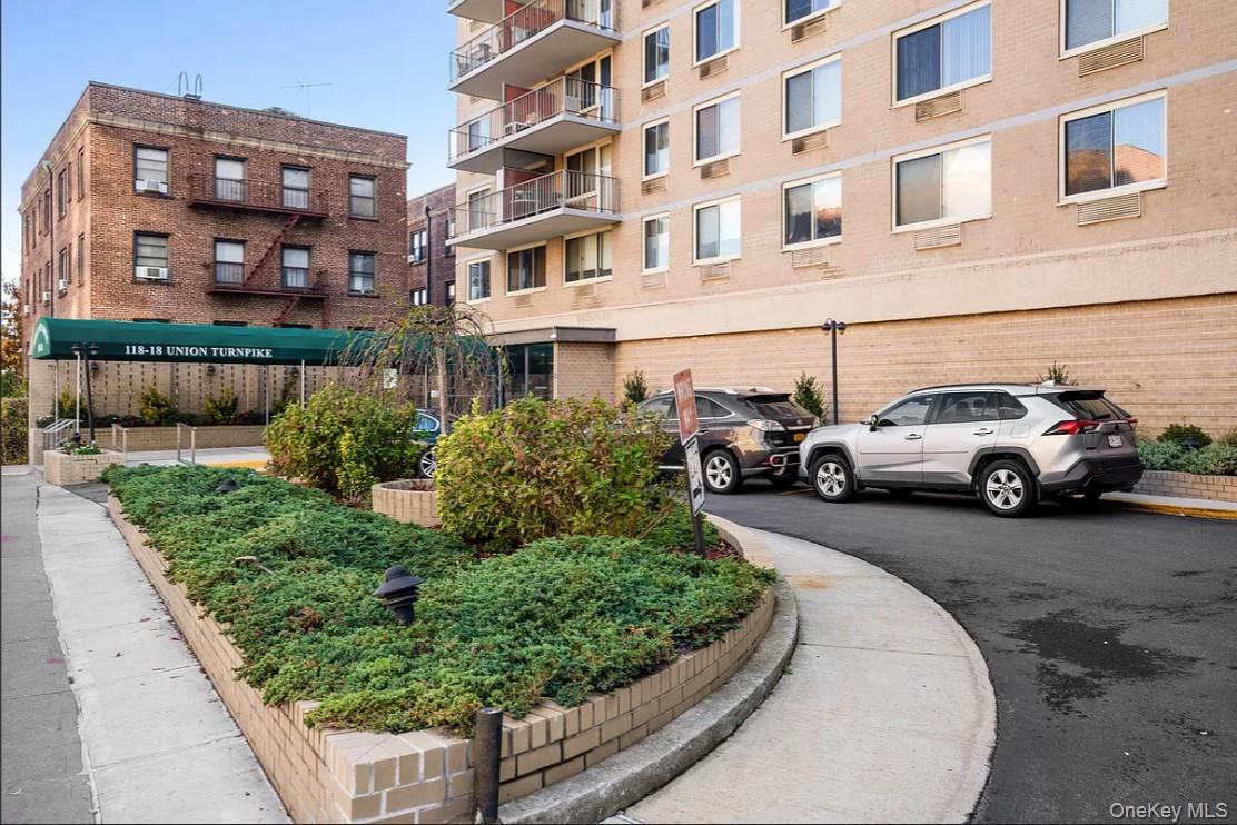 118-18 Union Turnpike, Unit 16A Queens, NY 11415 - Photo 3 of 13 a view of a cars park in front of a building
