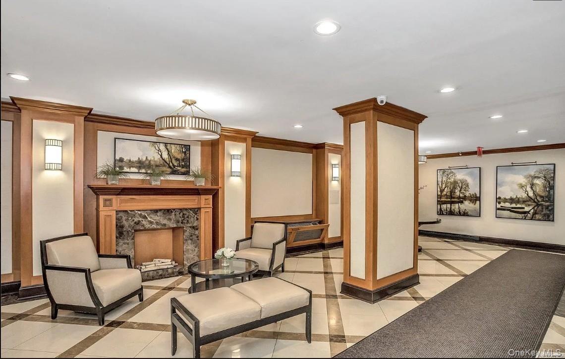 118-18 Union Turnpike, Unit 16A Queens, NY 11415 - Photo 5 of 13 a living room with furniture a window and a fireplace