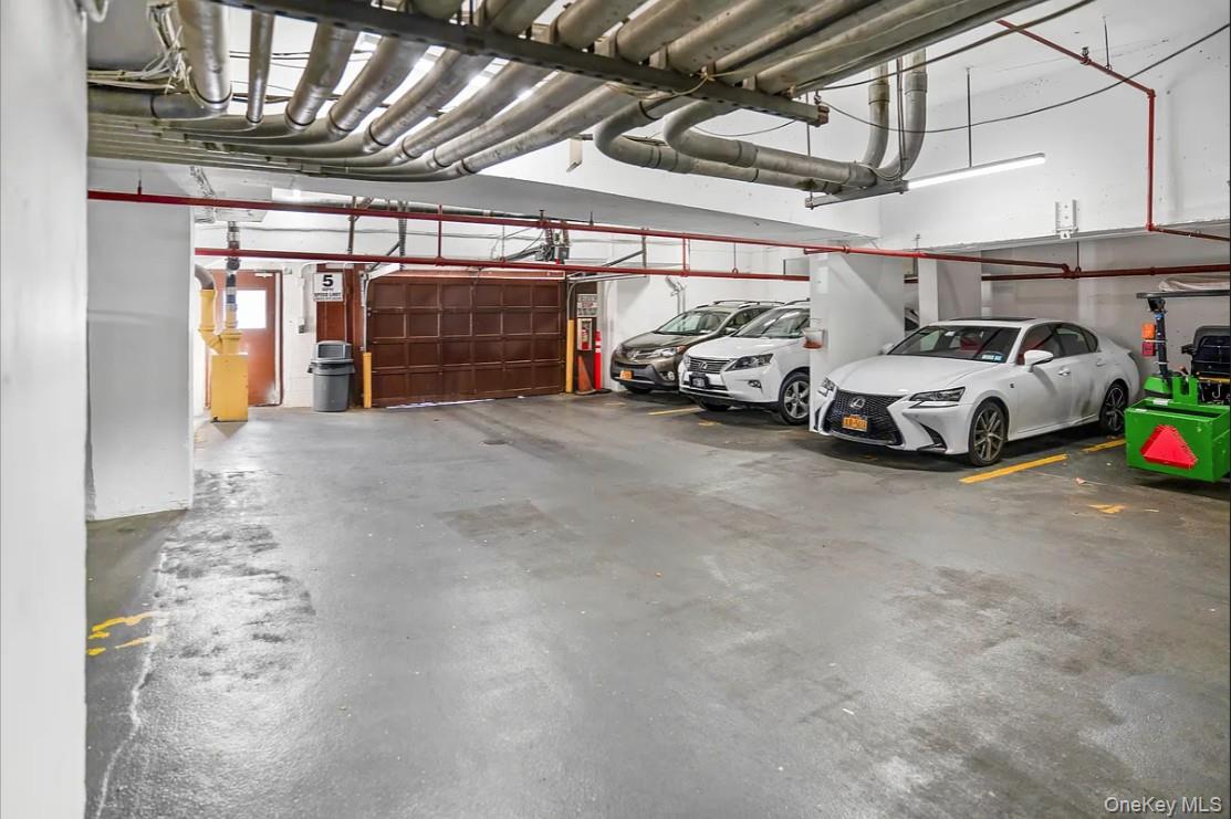 118-18 Union Turnpike, Unit 16A Queens, NY 11415 - Photo 7 of 13 a view of parking garage with cars