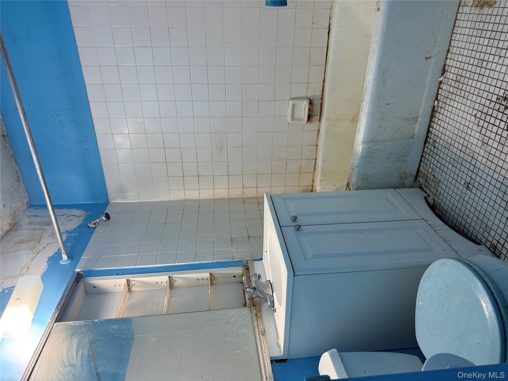 118-18 Union Turnpike, Unit 16A Queens, NY 11415 - Photo 9 of 13 a bathroom with a sink a toilet and shower