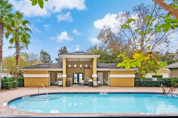 a view of house with outdoor space and swimming pool