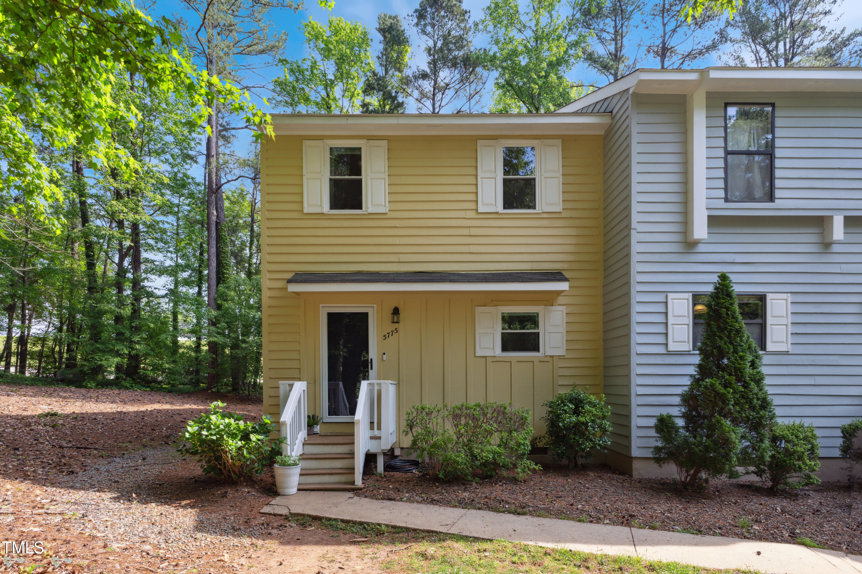 5775 Forest Lawn Court Raleigh, NC 27612 - Photo 1 of 45 a front view of a house with garden