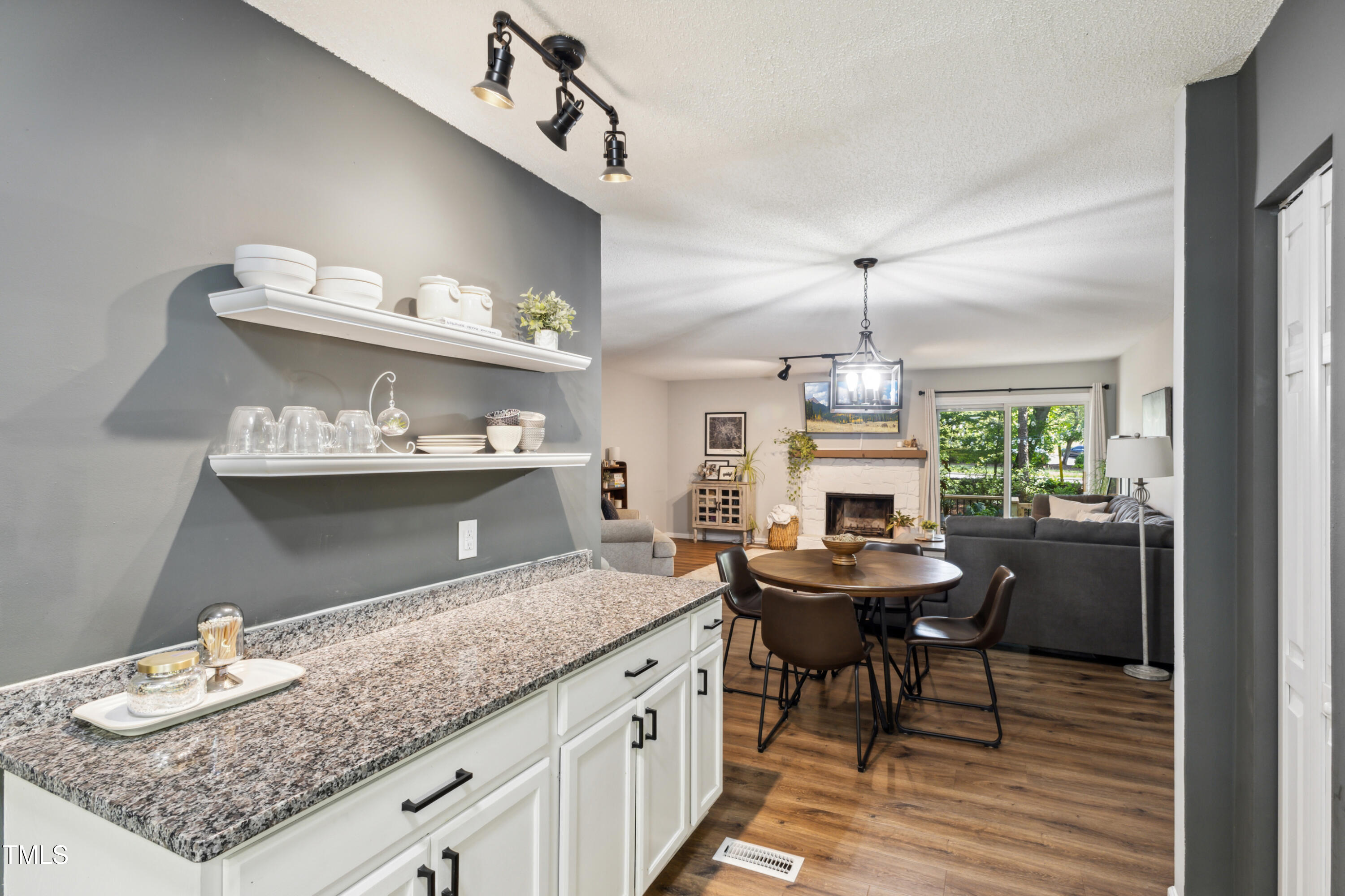5775 Forest Lawn Court Raleigh, NC 27612 - Photo 12 of 45 a kitchen with granite countertop kitchen island a table and chairs in it