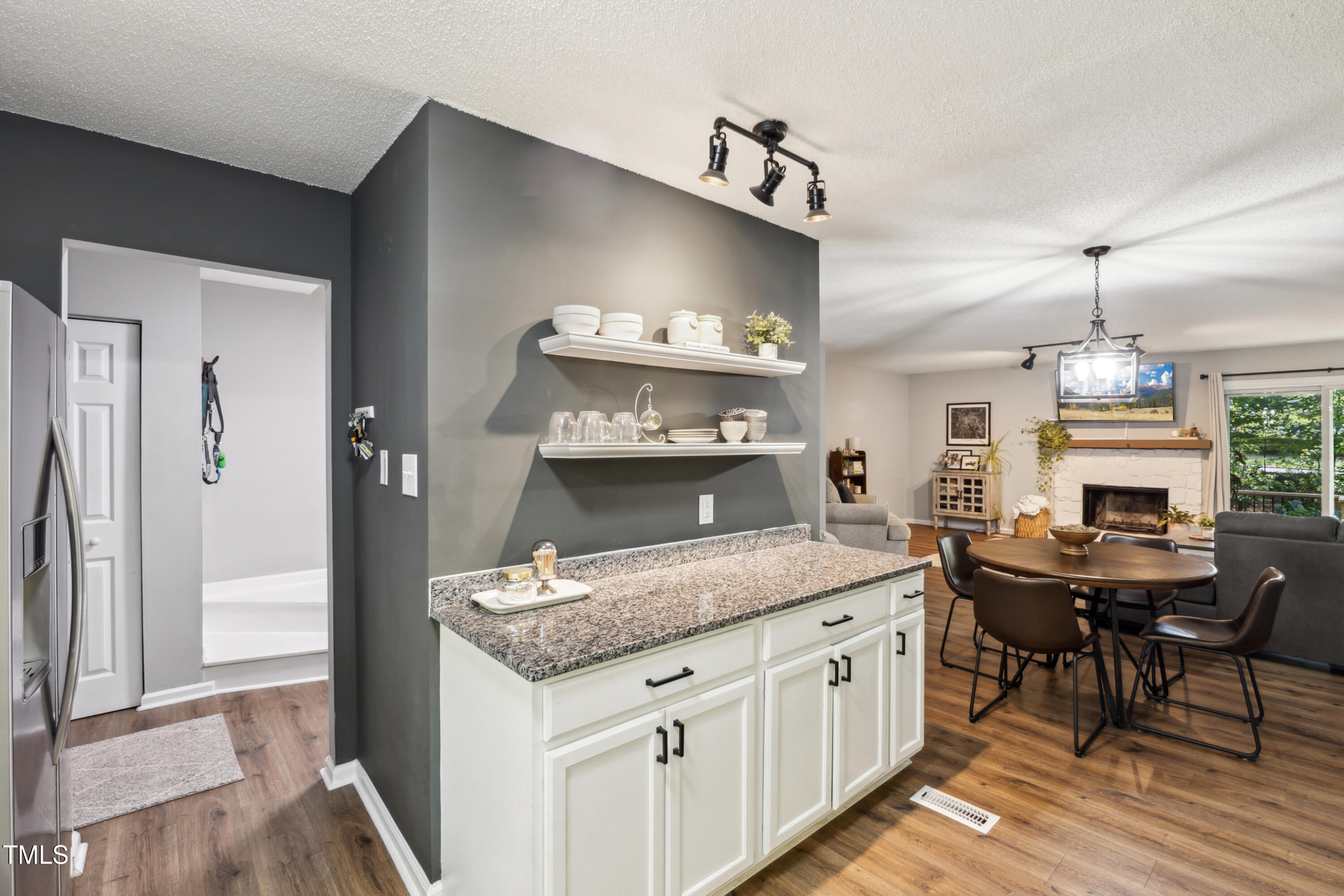 5775 Forest Lawn Court Raleigh, NC 27612 - Photo 13 of 45 a open kitchen with granite countertop a sink cabinets and wooden floor