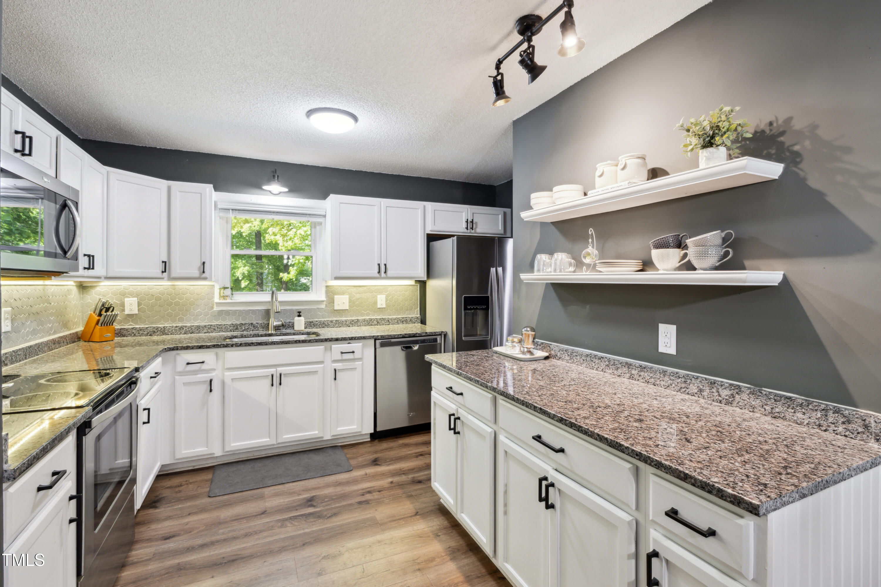 5775 Forest Lawn Court Raleigh, NC 27612 - Photo 18 of 45 a kitchen with granite countertop lots of counter top space