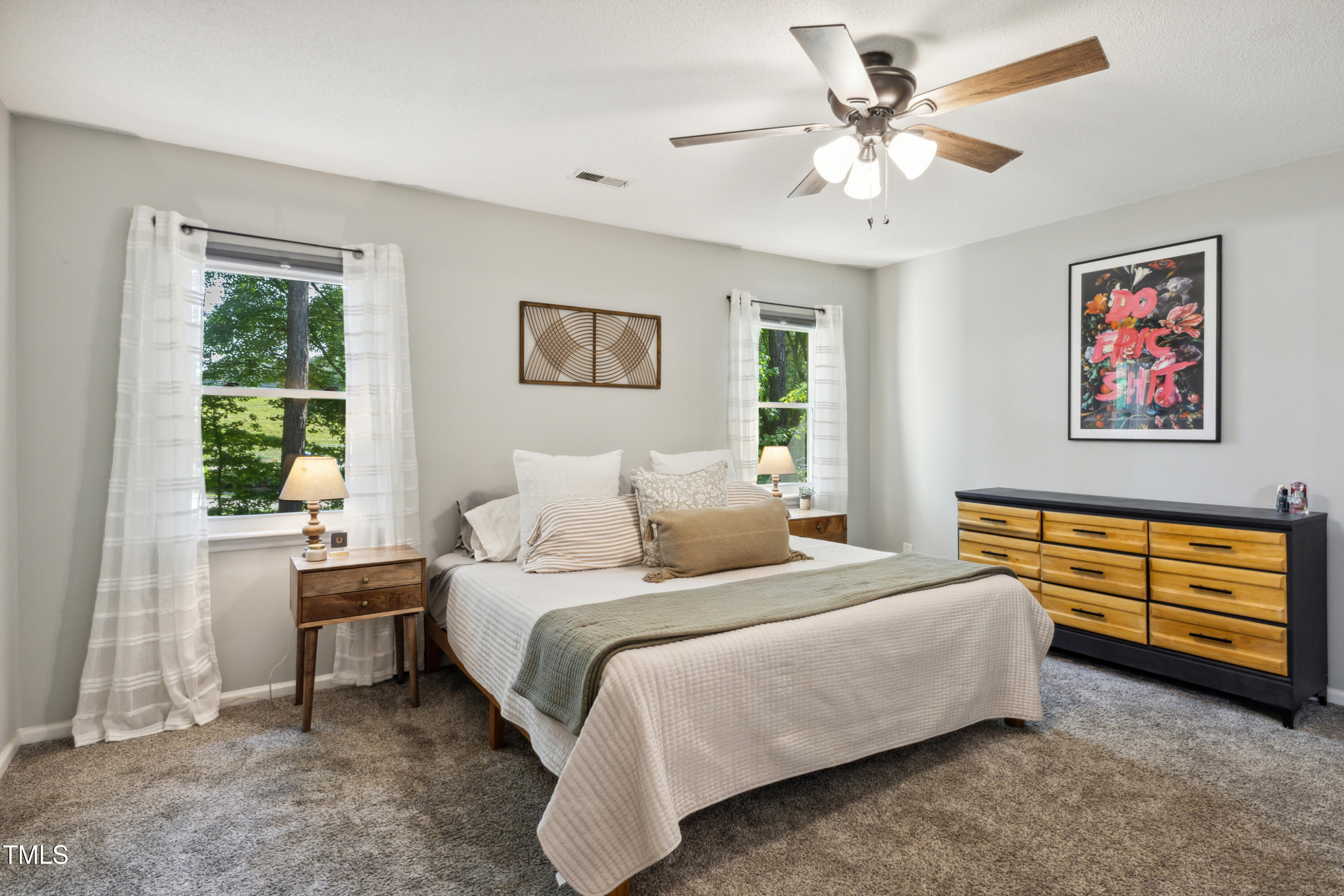 5775 Forest Lawn Court Raleigh, NC 27612 - Photo 19 of 45 a bedroom with a bed and a chandelier