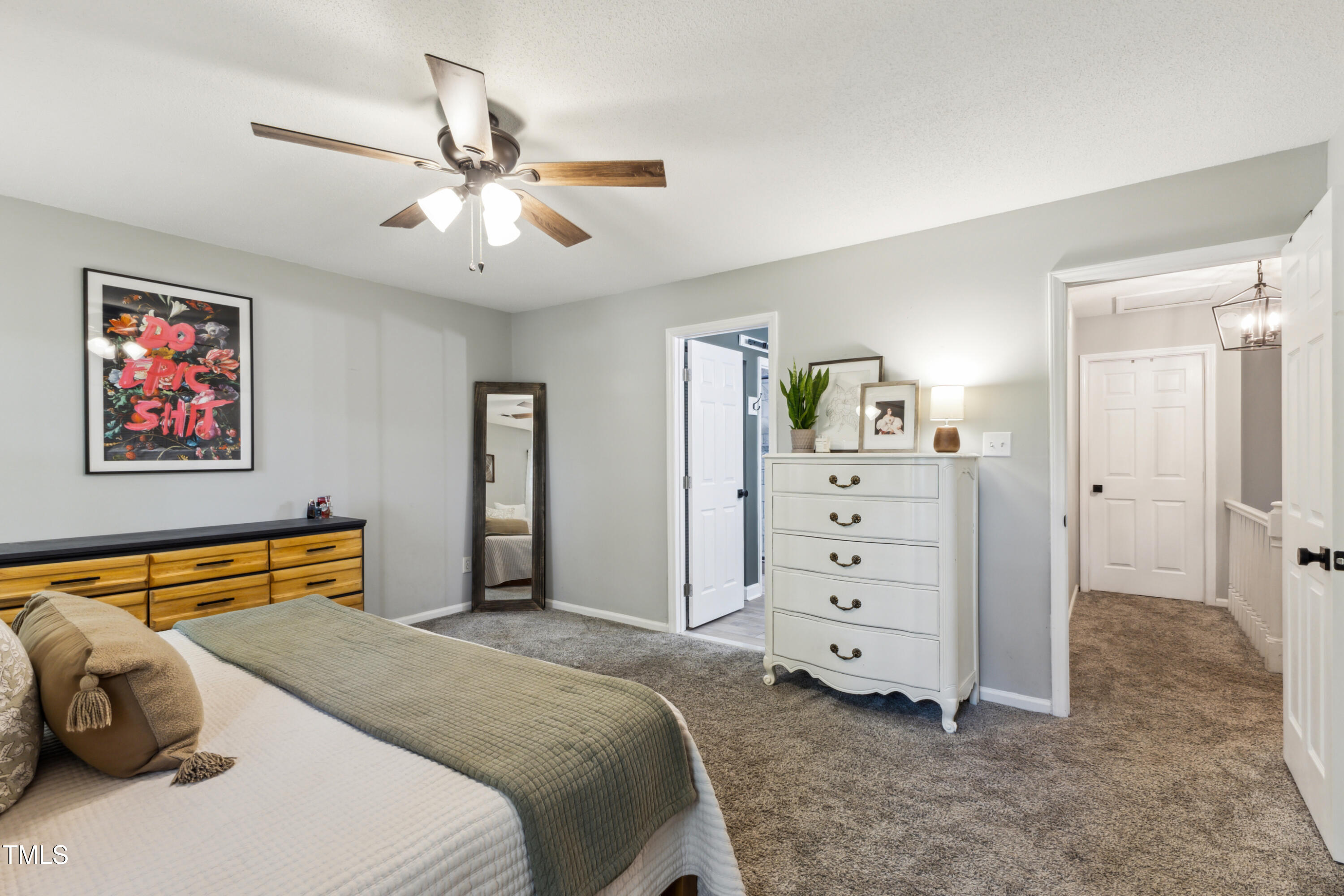 5775 Forest Lawn Court Raleigh, NC 27612 - Photo 20 of 45 a bedroom with a bed and a chandelier
