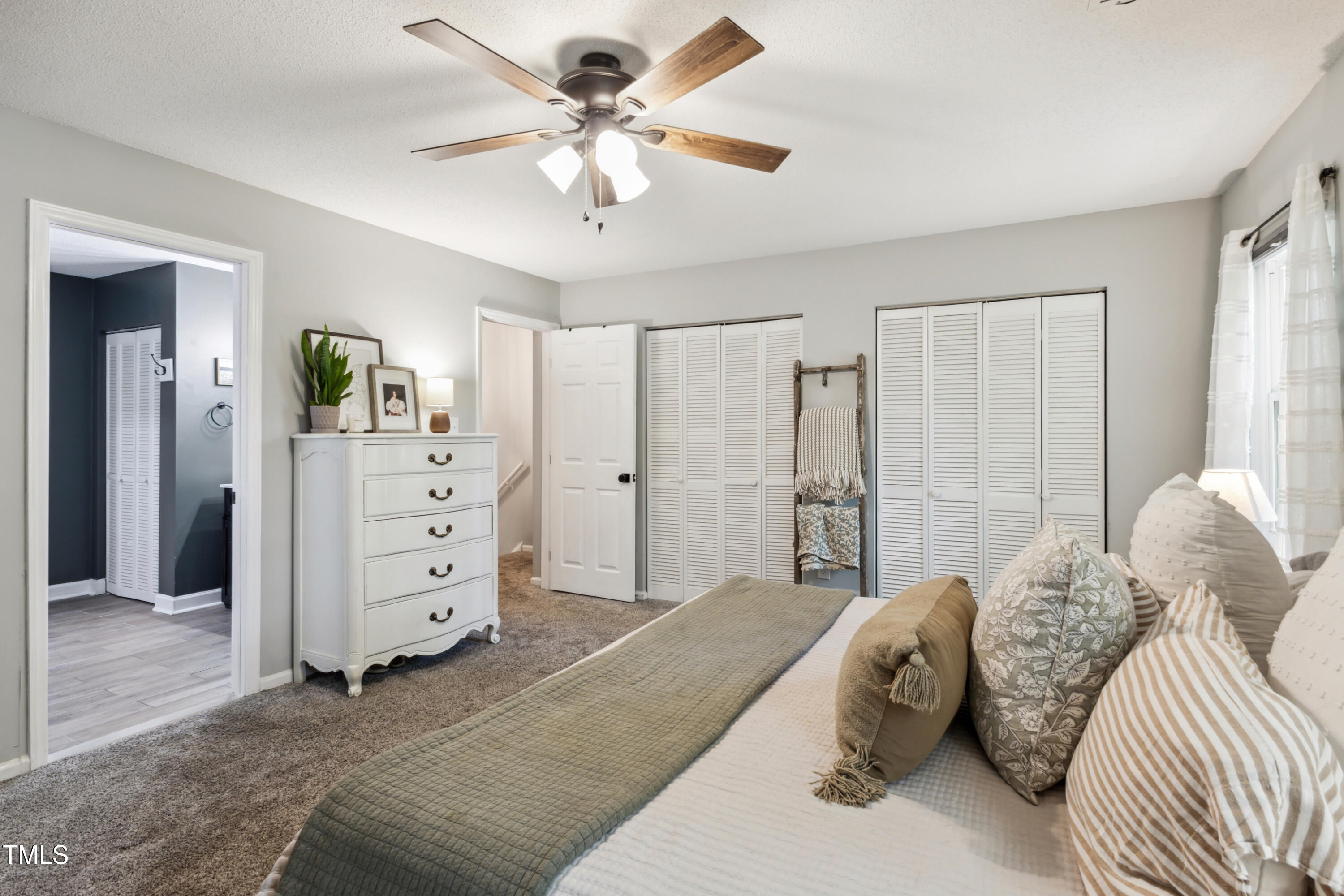 5775 Forest Lawn Court Raleigh, NC 27612 - Photo 21 of 45 a bedroom with a bed and a chandelier