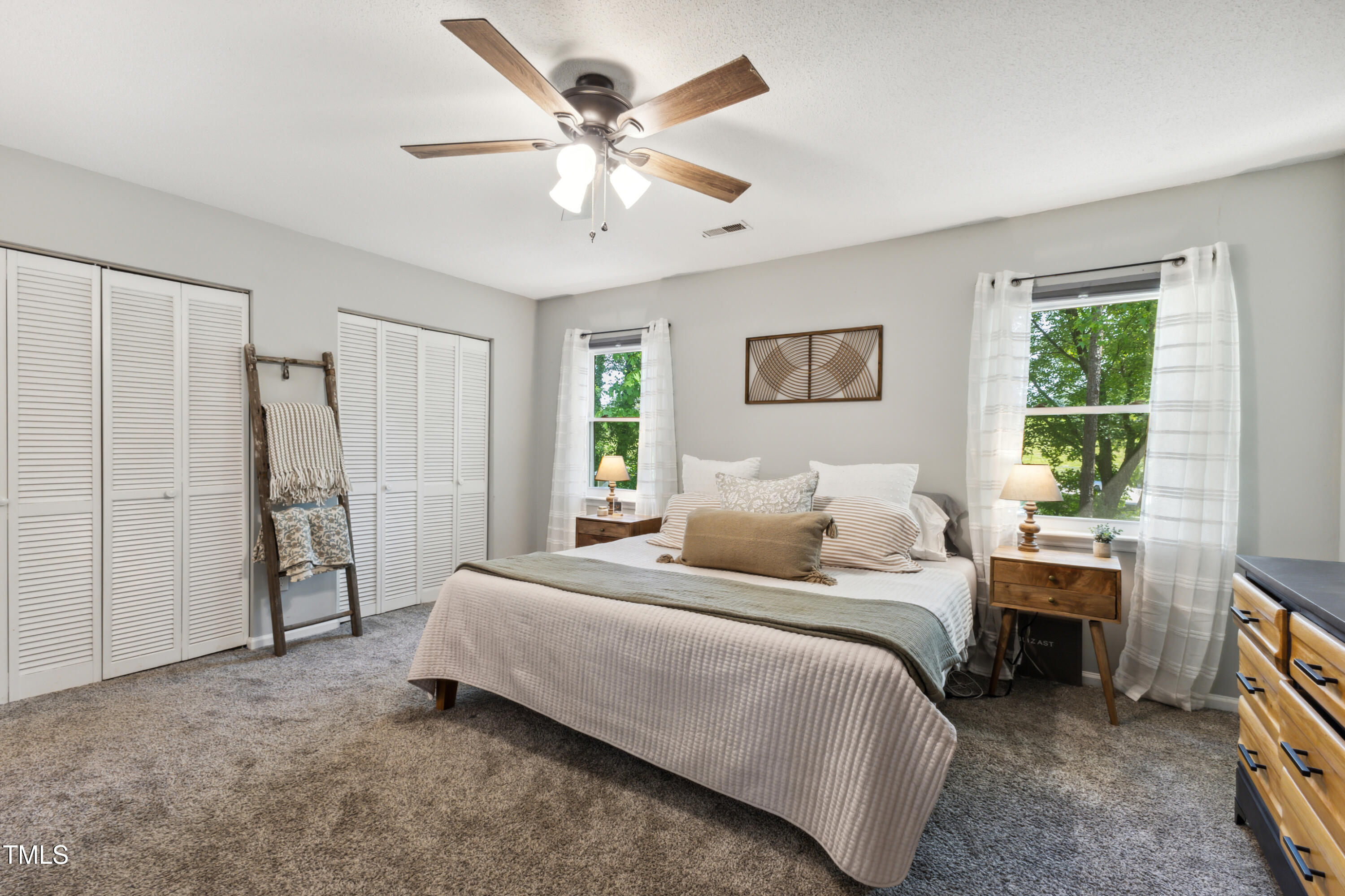 5775 Forest Lawn Court Raleigh, NC 27612 - Photo 22 of 45 a bedroom with a large bed and a window