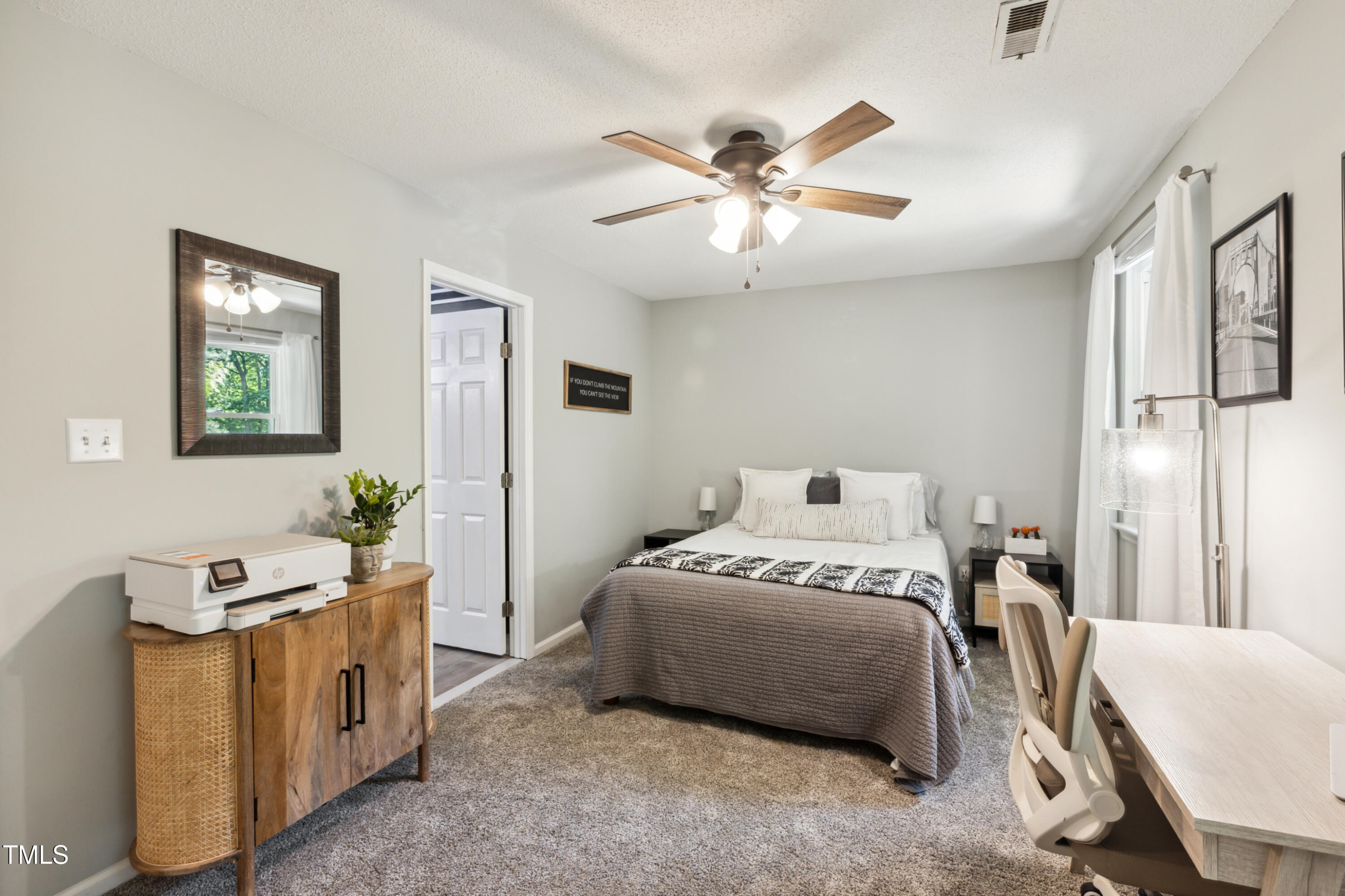 5775 Forest Lawn Court Raleigh, NC 27612 - Photo 24 of 45 a bedroom with a bed and a chandelier