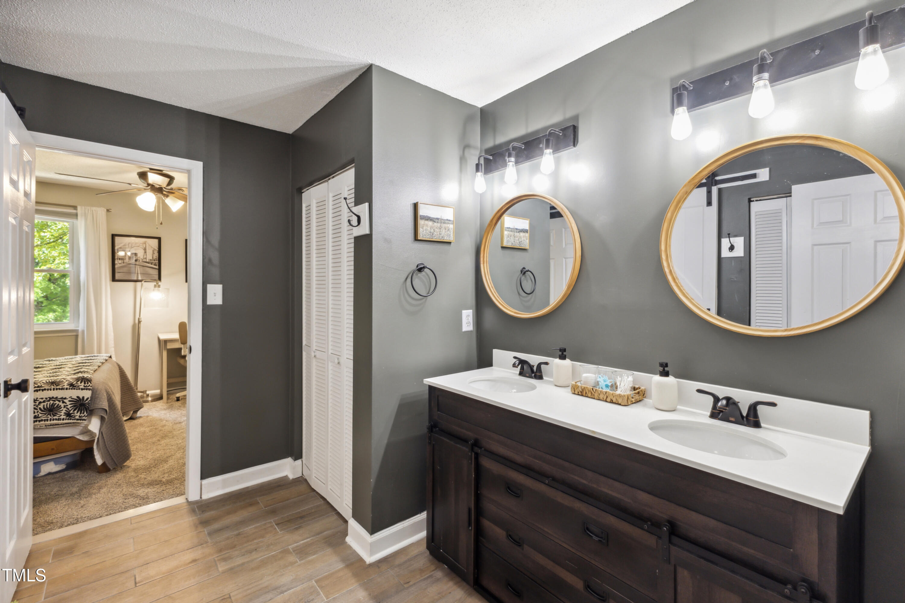 5775 Forest Lawn Court Raleigh, NC 27612 - Photo 27 of 45 a bathroom with a toilet sink and mirror