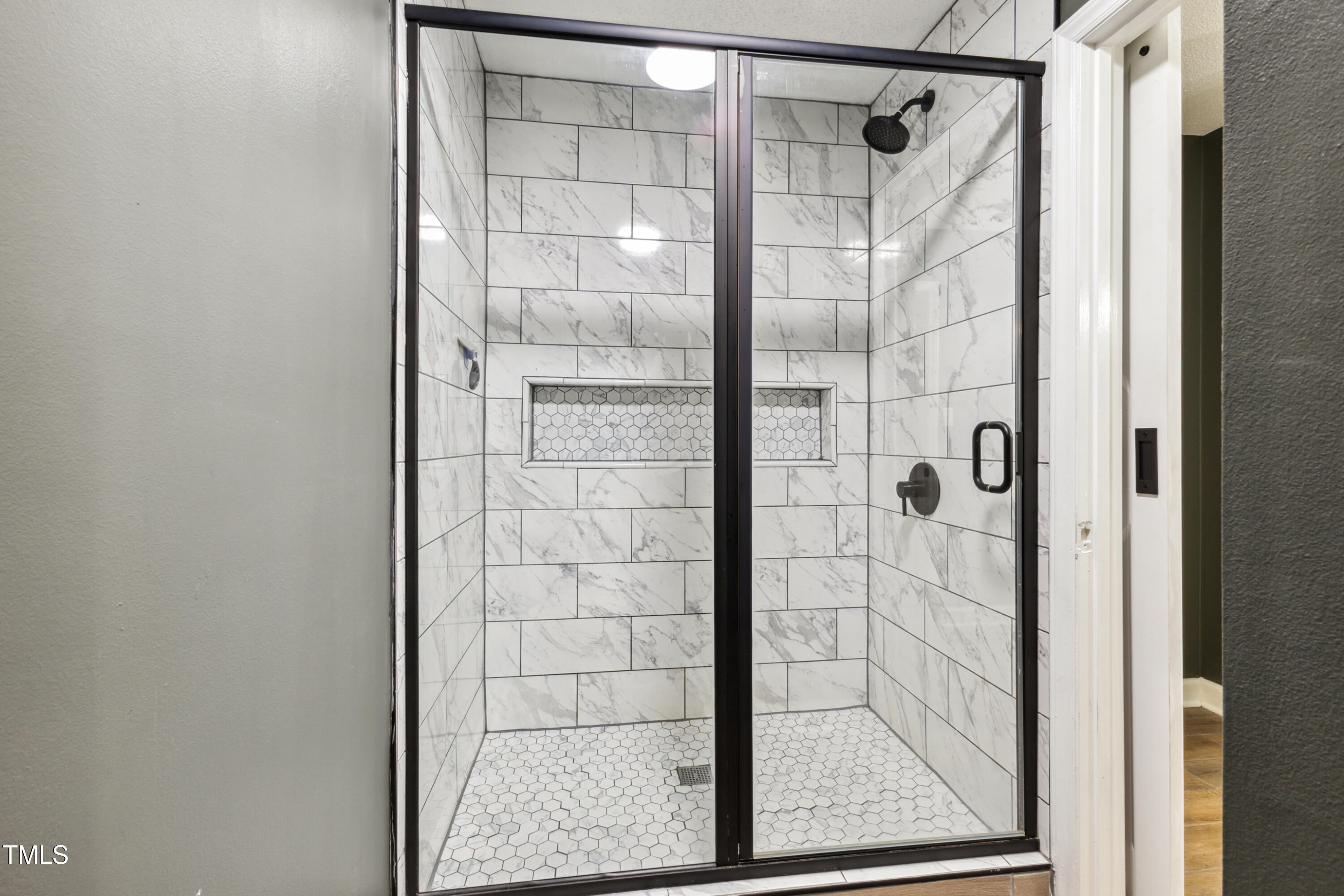 5775 Forest Lawn Court Raleigh, NC 27612 - Photo 30 of 45 a bathroom with a glass door shower