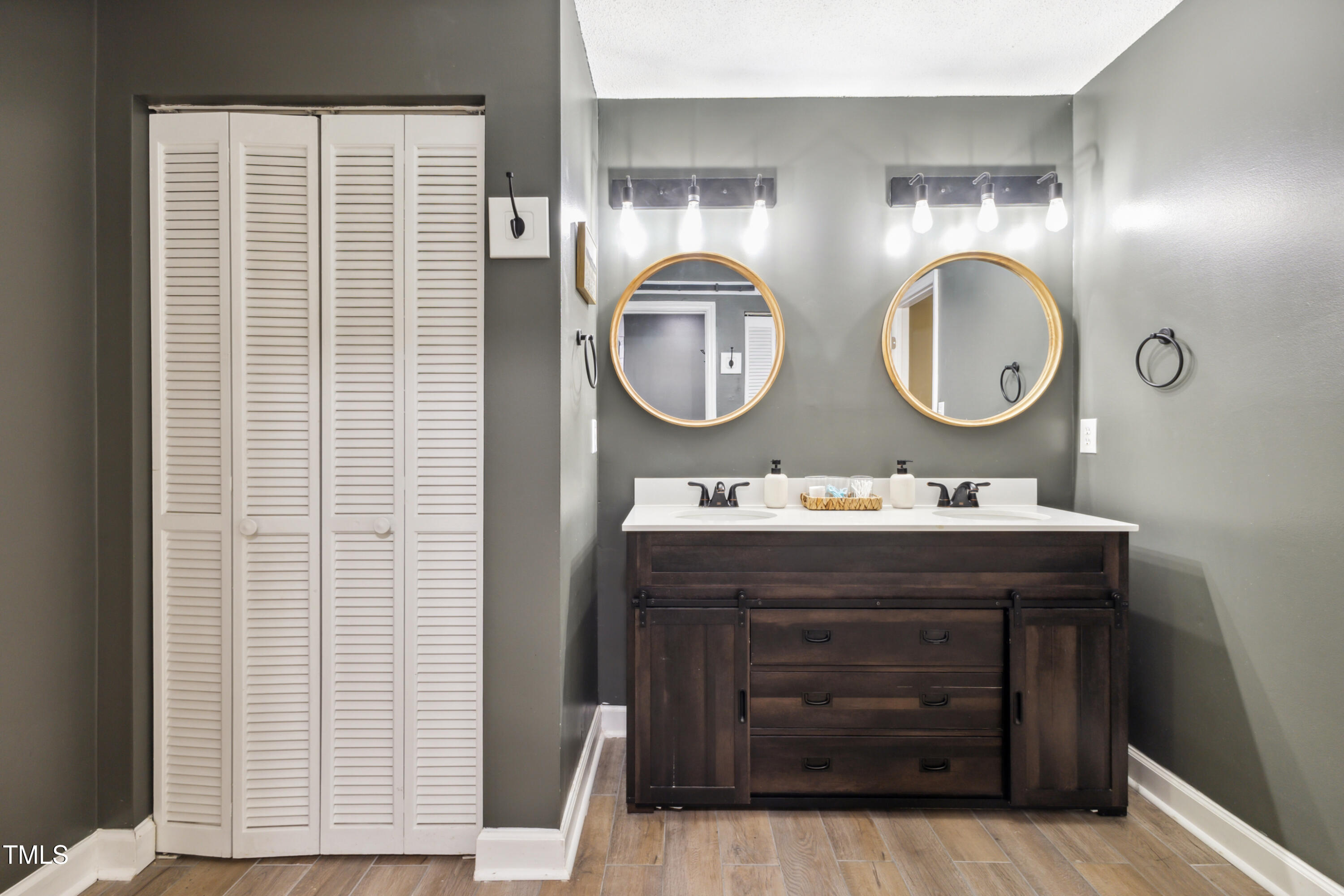 5775 Forest Lawn Court Raleigh, NC 27612 - Photo 31 of 45 a bathroom with a sink and a mirror