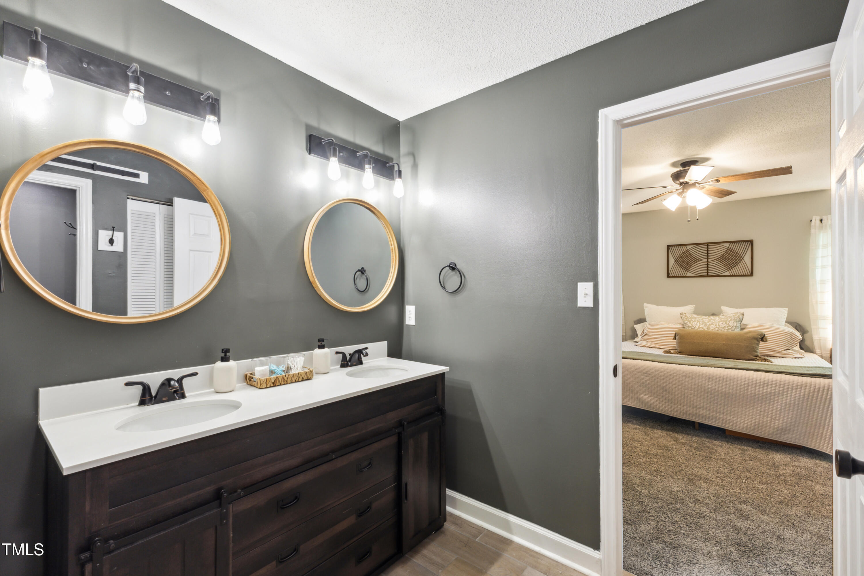 5775 Forest Lawn Court Raleigh, NC 27612 - Photo 32 of 45 a en suite bathroom with a double vanity sink and a mirror