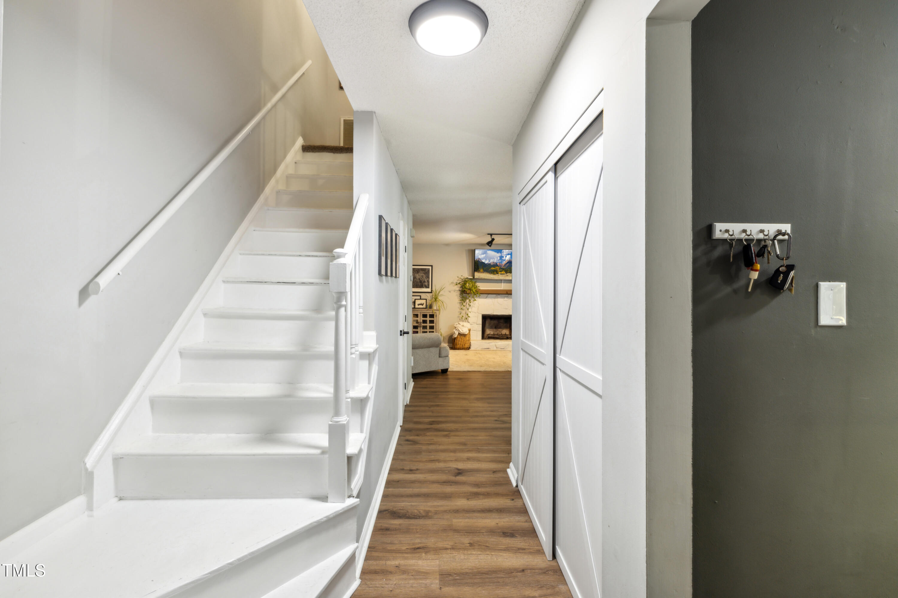 5775 Forest Lawn Court Raleigh, NC 27612 - Photo 4 of 45 a view of a hallway with wooden floor and staircase
