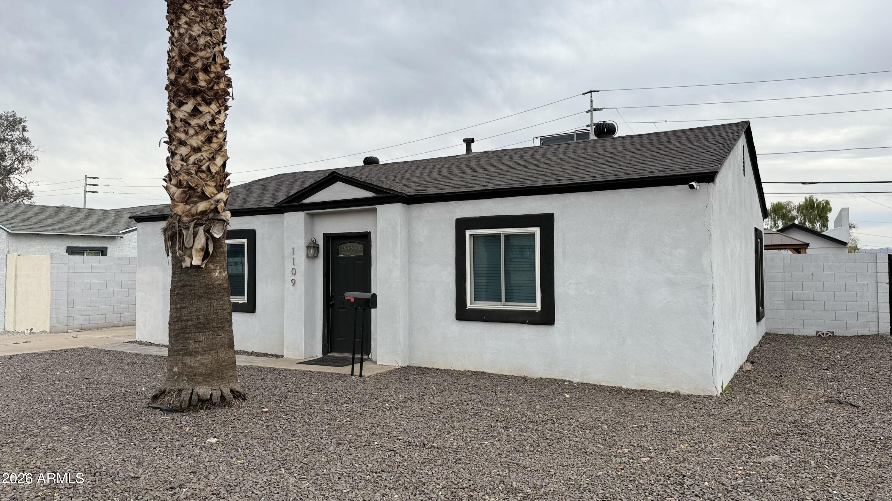 1109 West Indian School Road Phoenix, AZ 85013 - Photo 4 of 38 a front view of a house with a yard