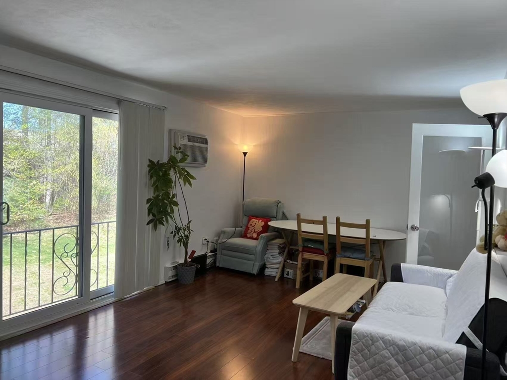 382 Great Road, Unit B303 Acton, MA 01720 - Photo 3 of 8 a living room with furniture and wooden floor