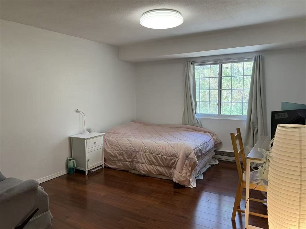 382 Great Road, Unit B303 Acton, MA 01720 - Photo 6 of 8 a bedroom with a bed and a window