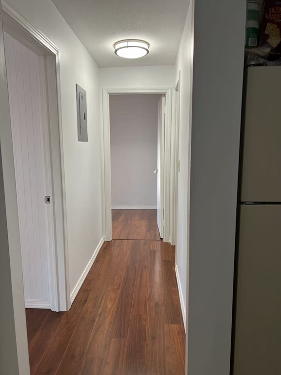 382 Great Road, Unit B303 Acton, MA 01720 - Photo 8 of 8 a view of a hallway with wooden floor