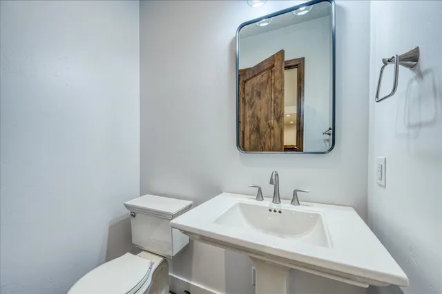 a bedroom with a bed and large window