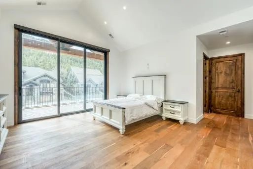 a bedroom with a bed and a large window