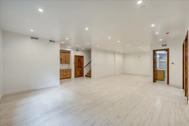 a kitchen with white cabinets and sink