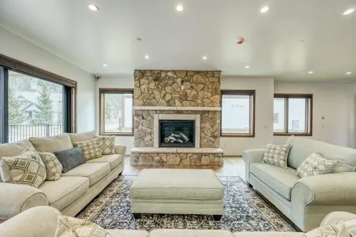 a living room with furniture and a view of kitchen