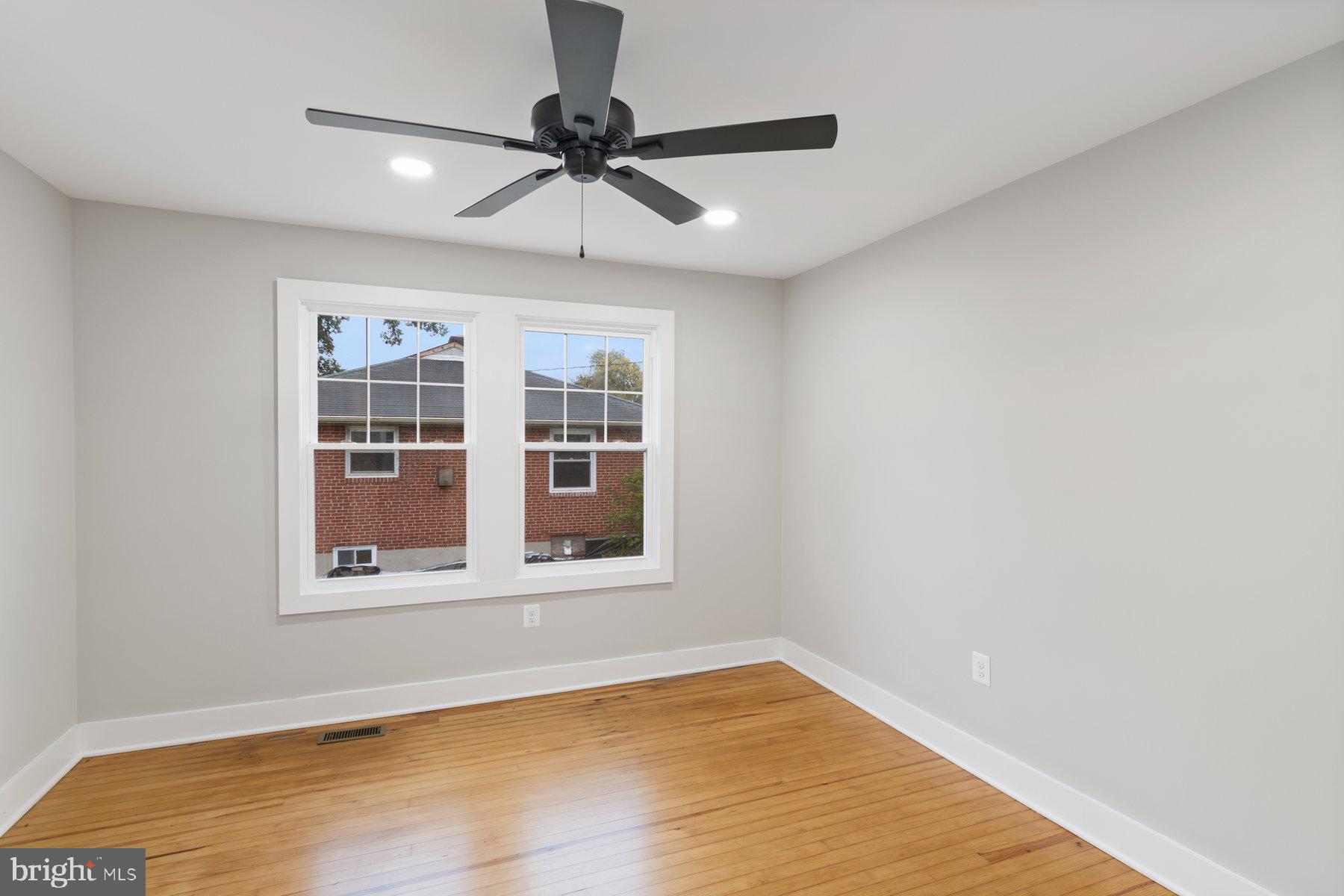 509 Valcour Road Catonsville, MD 21228 - Photo 6 of 40 a view of an empty room with a window and wooden floor