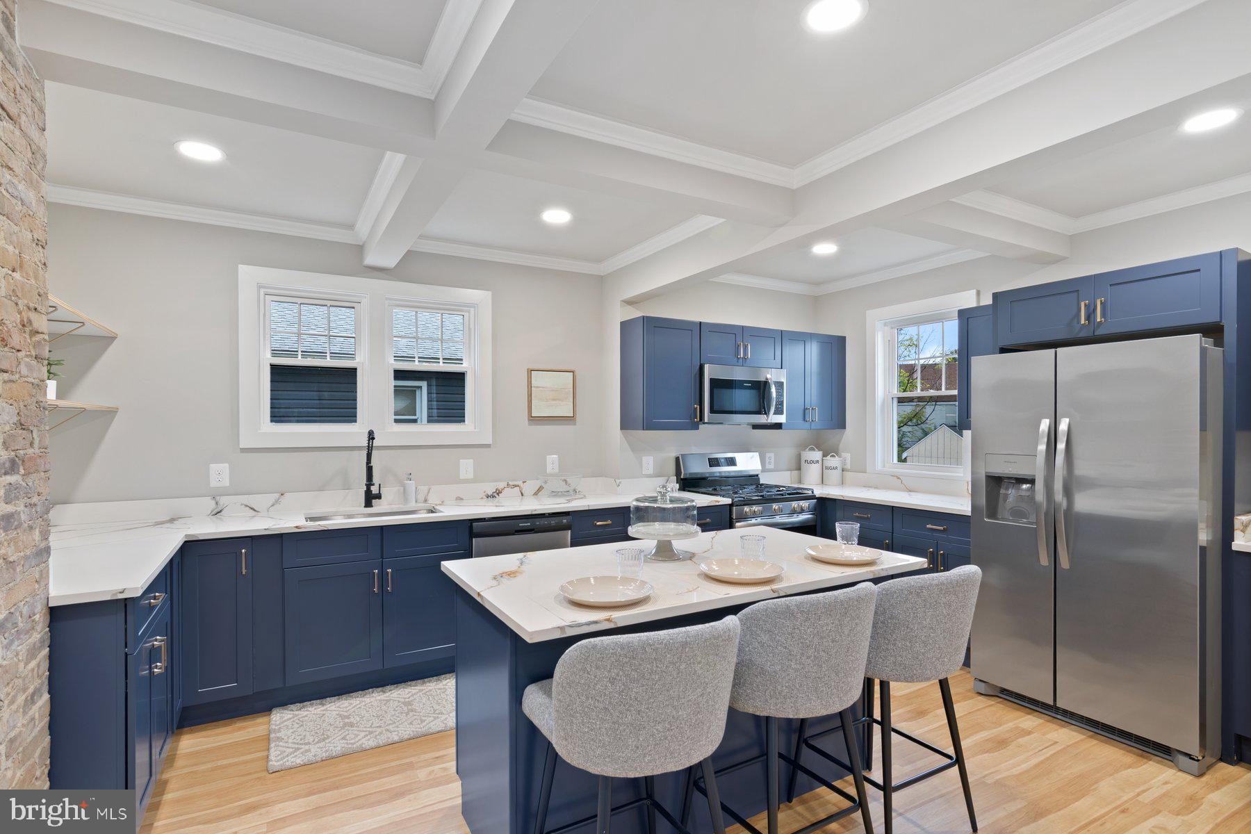 509 Valcour Road Catonsville, MD 21228 - Photo 9 of 40 a kitchen with a dining table chairs refrigerator and sink