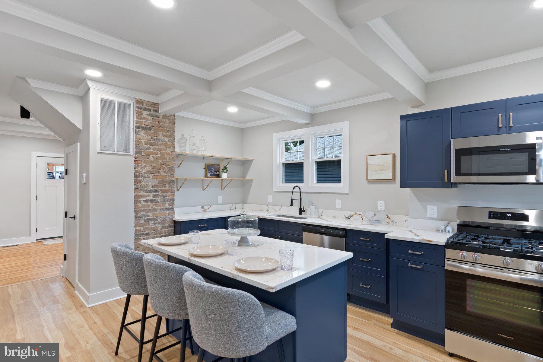 509 Valcour Road Catonsville, MD 21228 - Photo 10 of 40 a kitchen with stainless steel appliances kitchen island granite countertop a sink and cabinets