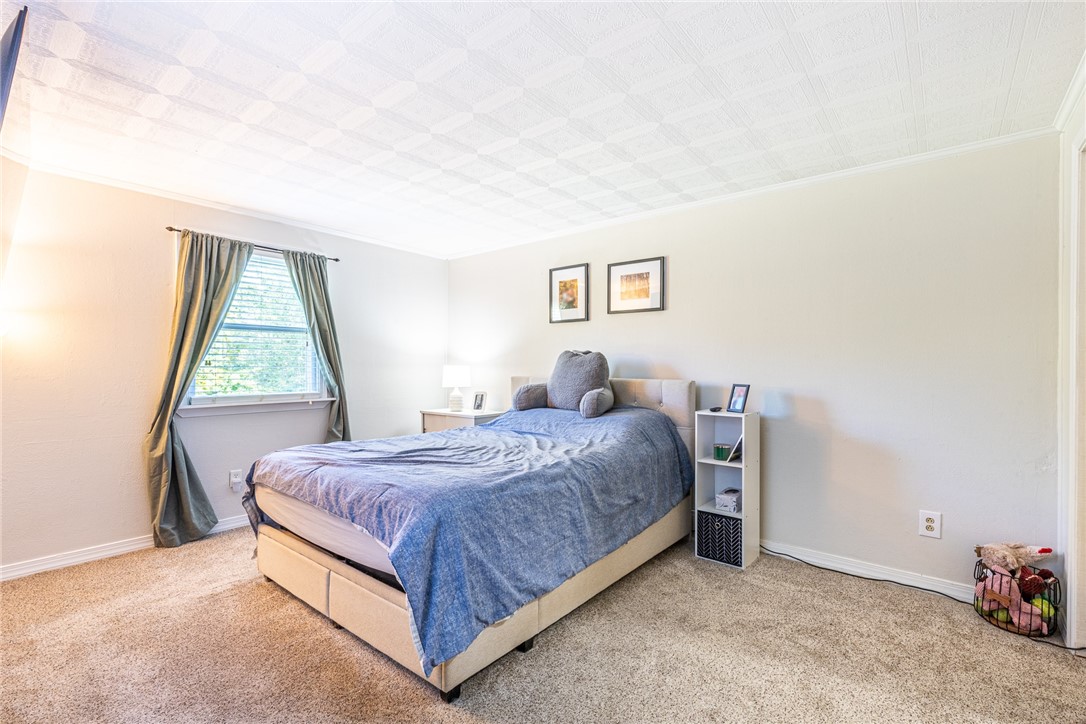 6432 Lakeside Road Ontario, NY 14519 - Photo 27 of 35 Soft carpeting underfoot pairs with textured ceiling details and a wide window.