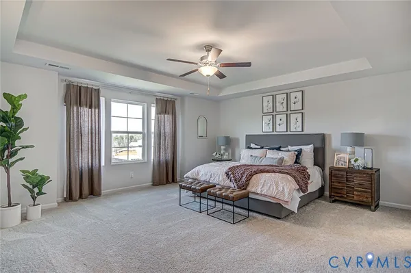 a spacious bedroom with a bed and a window