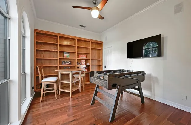 a view of a workspace with furniture and a flat screen tv