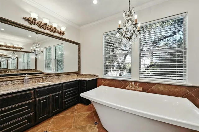 a bathroom with a granite countertop sink a large mirror and a bathtub with shower
