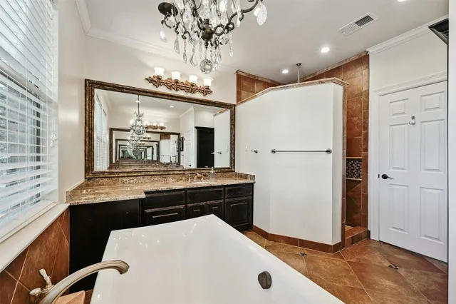 a kitchen with kitchen island a counter top space a refrigerator a stove and a window