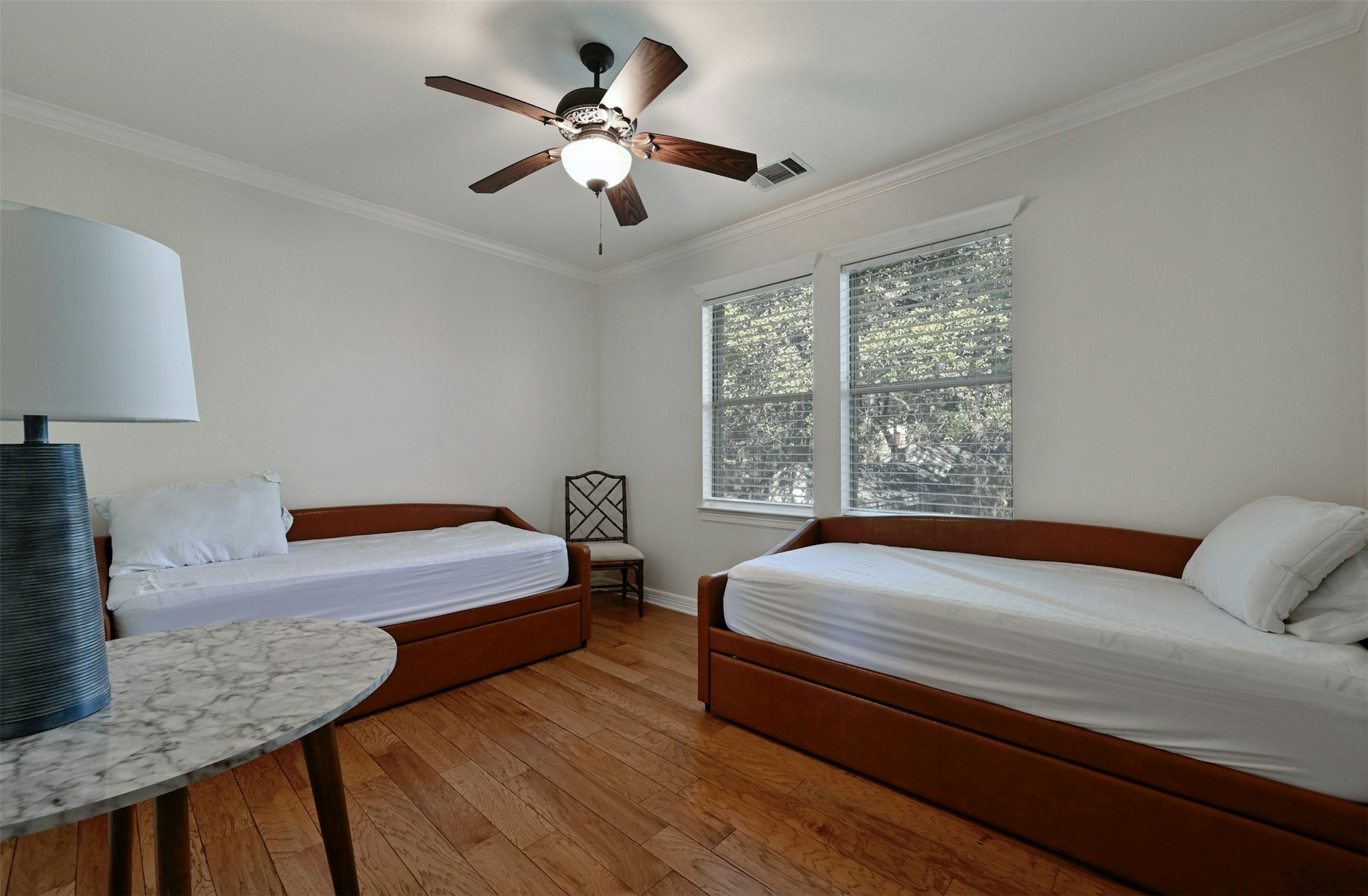 5606 Craggy Point Austin, TX 78731 - Photo 23 of 39 a bedroom with a large bed a chandelier and a window