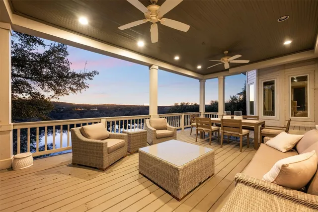 a living room with patio furniture and a wooden floor