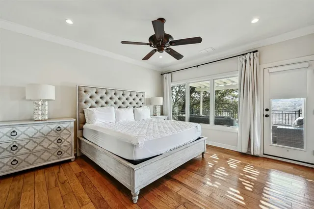 a white bed sitting in a bedroom next to a window