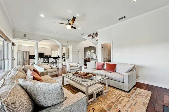 a living room with furniture ceiling fan and a rug