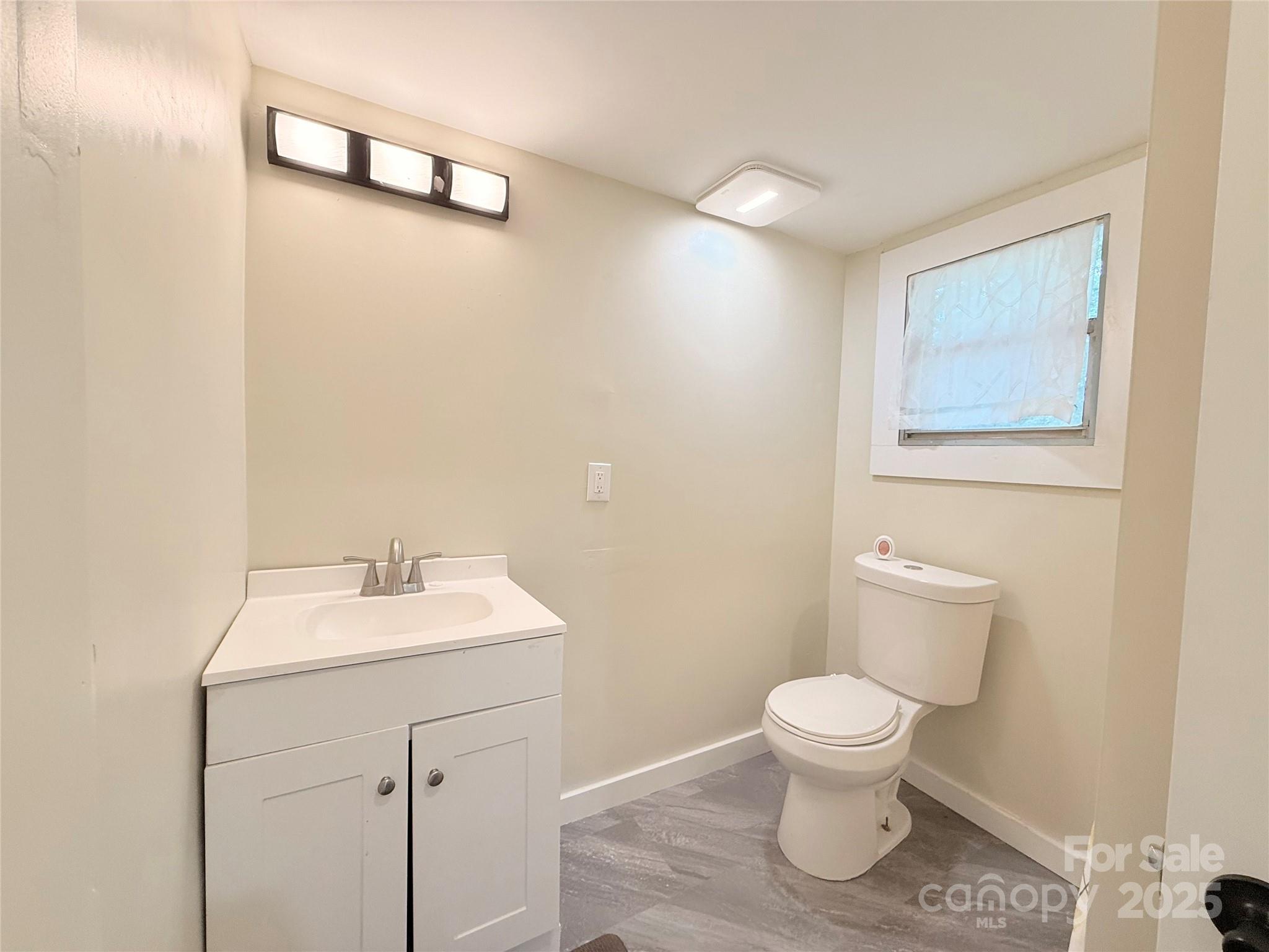 3465 Peniel Road Tryon, NC 28782 - Photo 14 of 21 a bathroom with a toilet sink and mirror