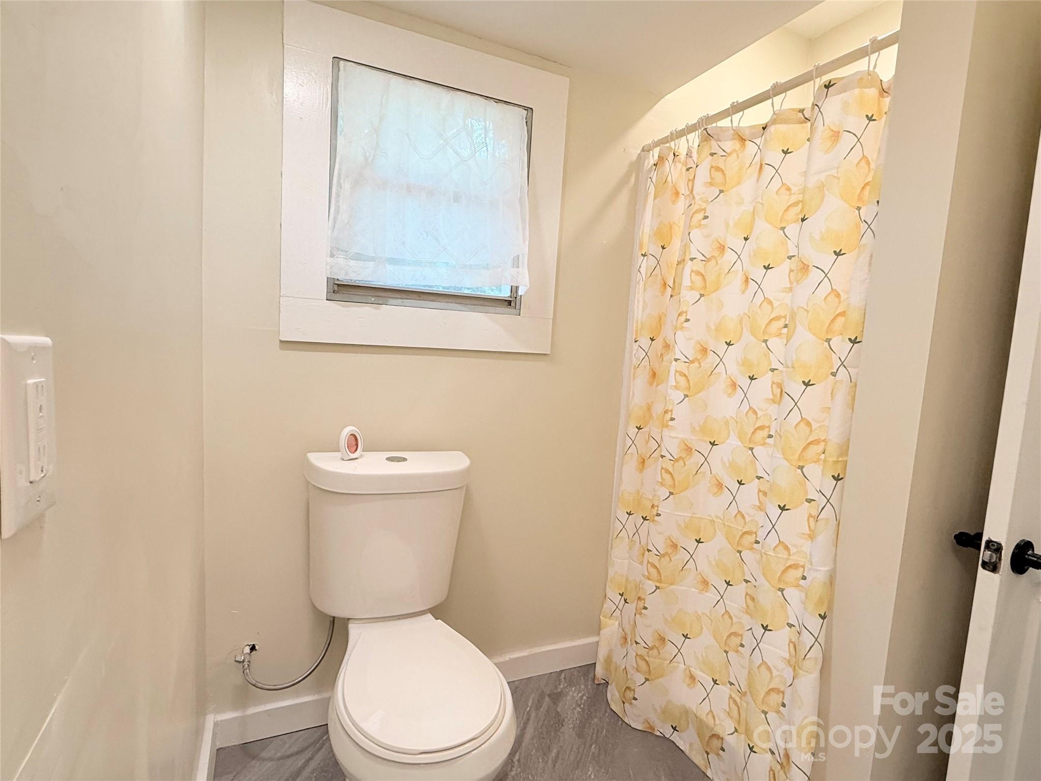 3465 Peniel Road Tryon, NC 28782 - Photo 15 of 21 a white toilet sitting next to a shower curtain