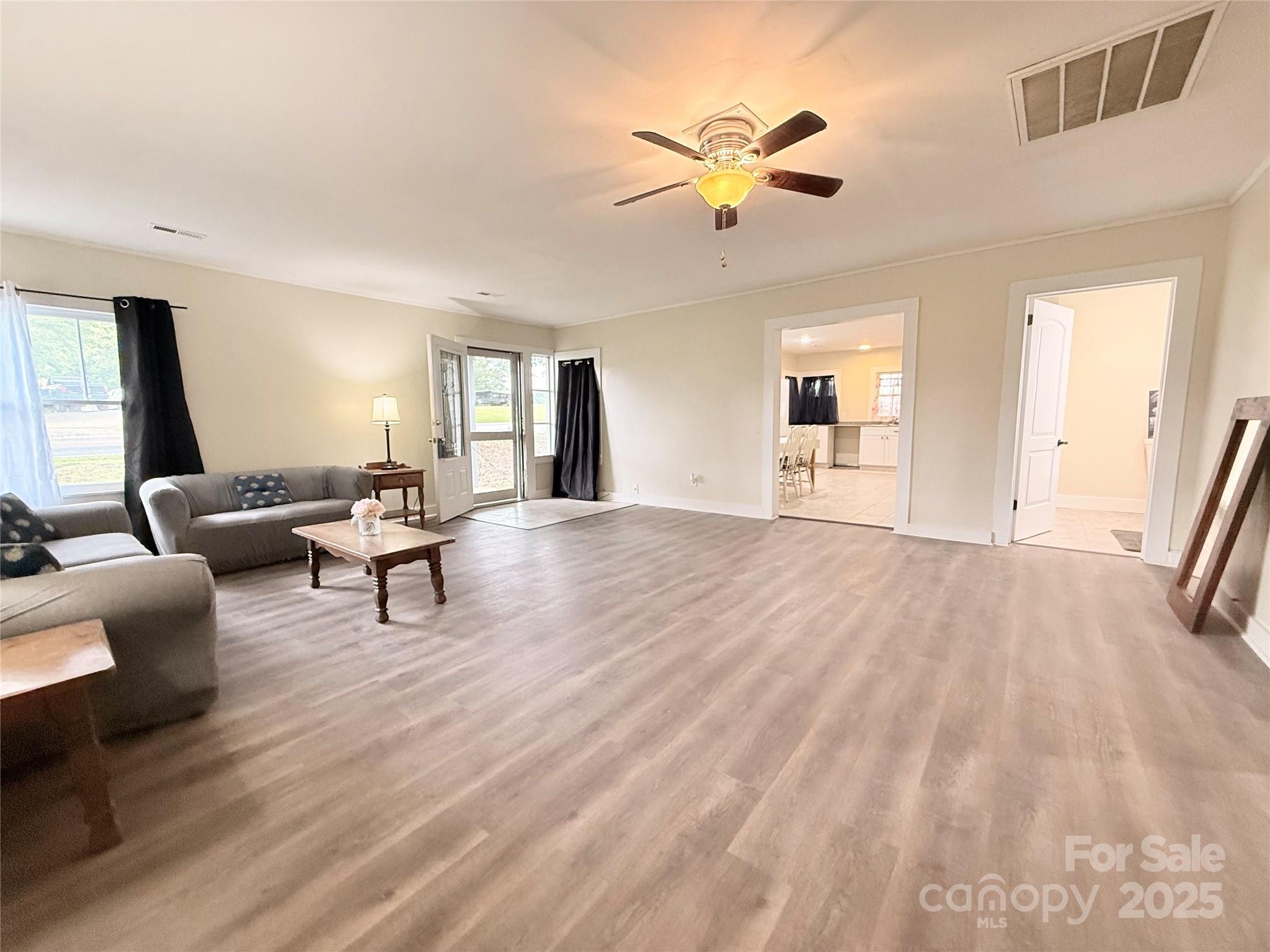 3465 Peniel Road Tryon, NC 28782 - Photo 3 of 21 a view of an empty room with window and wooden floor