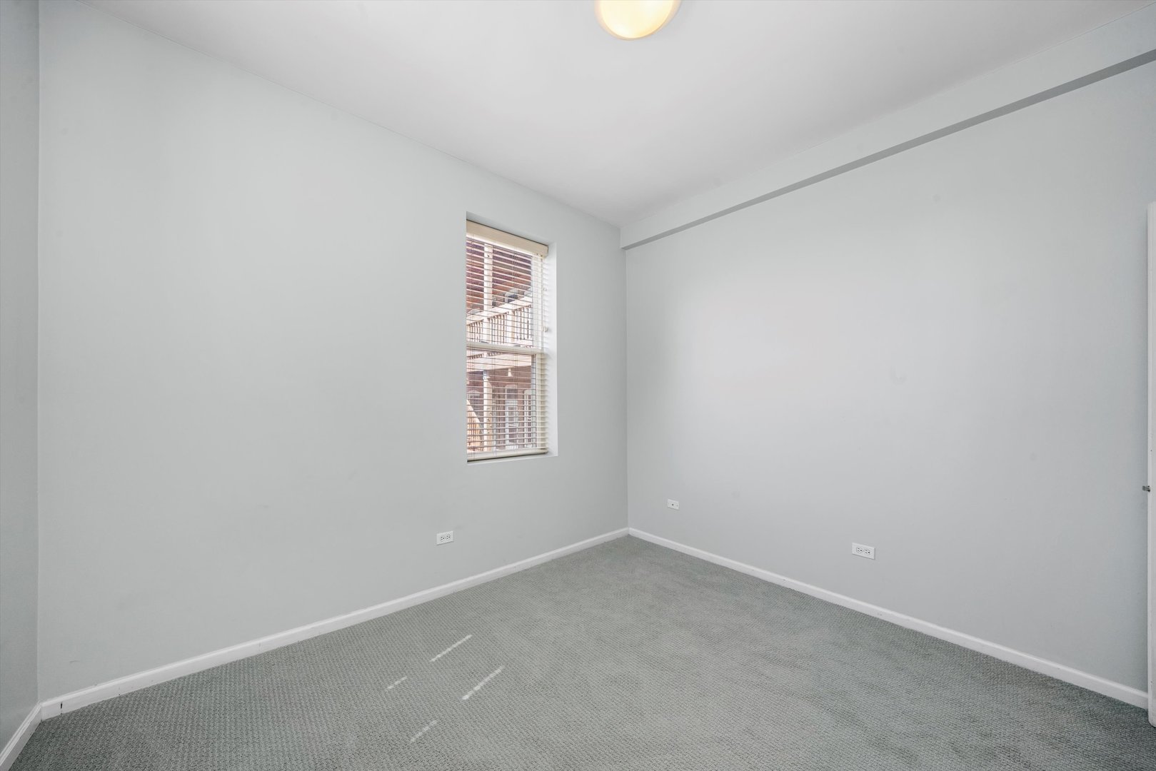 4536 North Sheridan Road, Unit 204 Chicago, IL 60640 - Photo 11 of 24 an empty room with a window