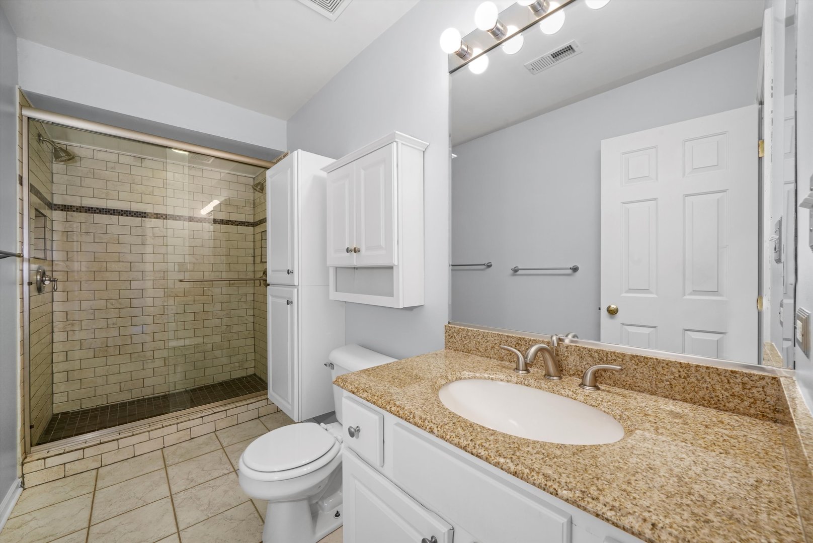 4536 North Sheridan Road, Unit 204 Chicago, IL 60640 - Photo 16 of 24 a bathroom with a granite countertop sink toilet and shower