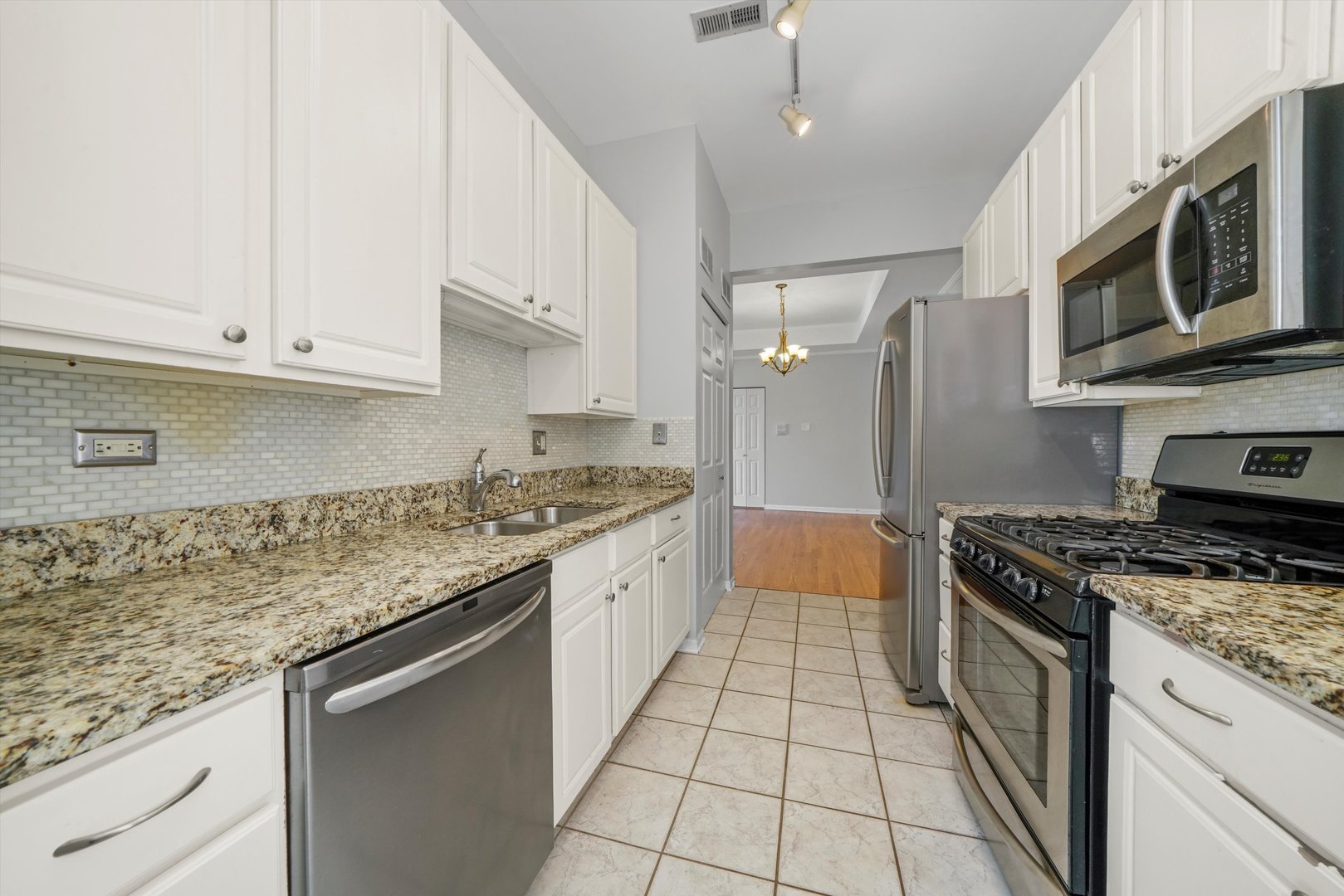 4536 North Sheridan Road, Unit 204 Chicago, IL 60640 - Photo 9 of 24 a kitchen with stainless steel appliances granite countertop a granite counter tops and a stove