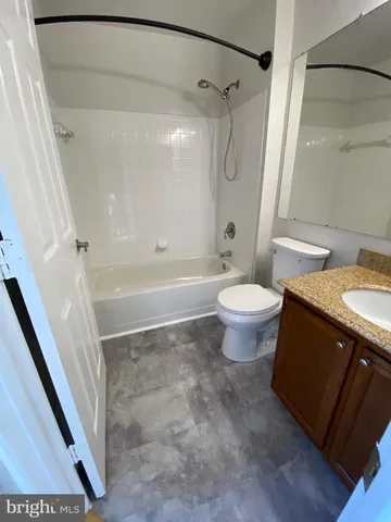 a bathroom with a sink a toilet and a shower