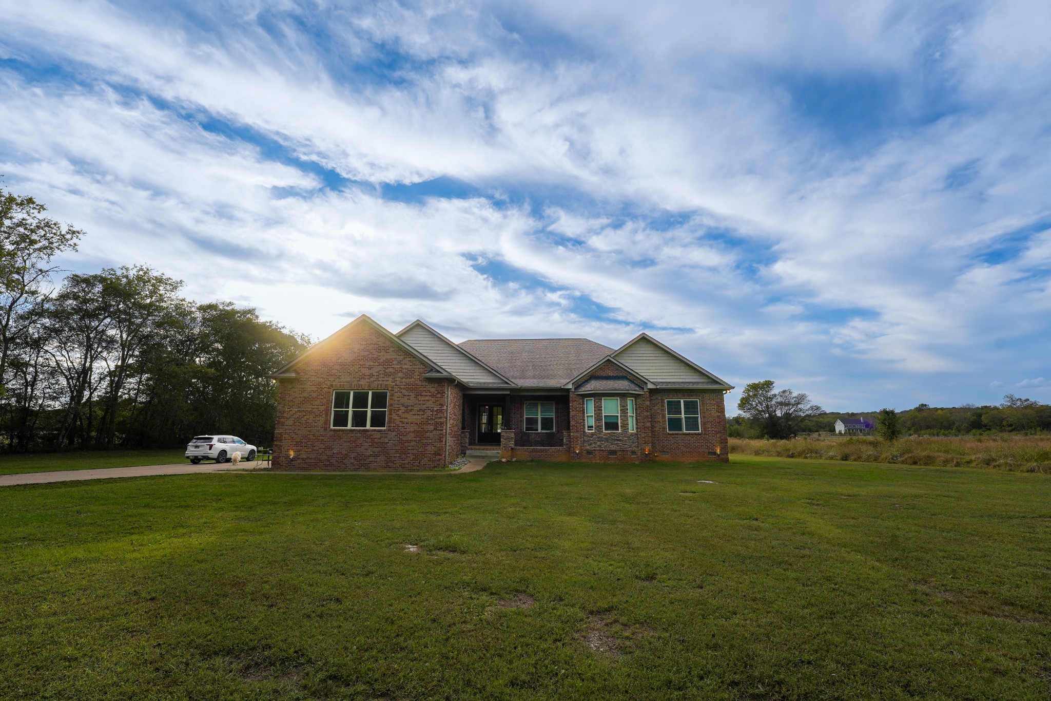 a front view of house with yard and green space