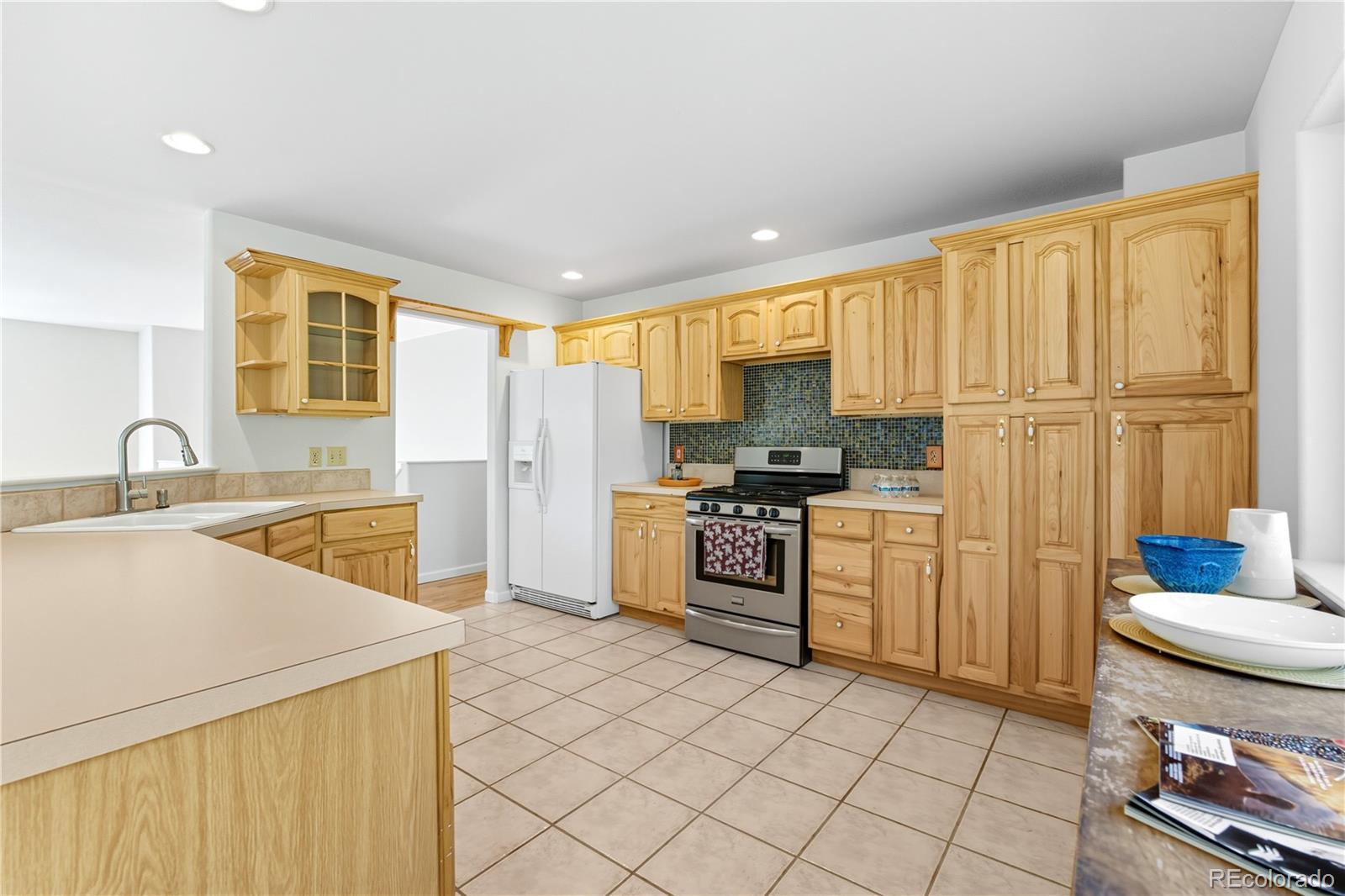 4 Gap Road Black Hawk, CO 80422 - Photo 11 of 43 a kitchen with a sink a stove cabinets and a refrigerator