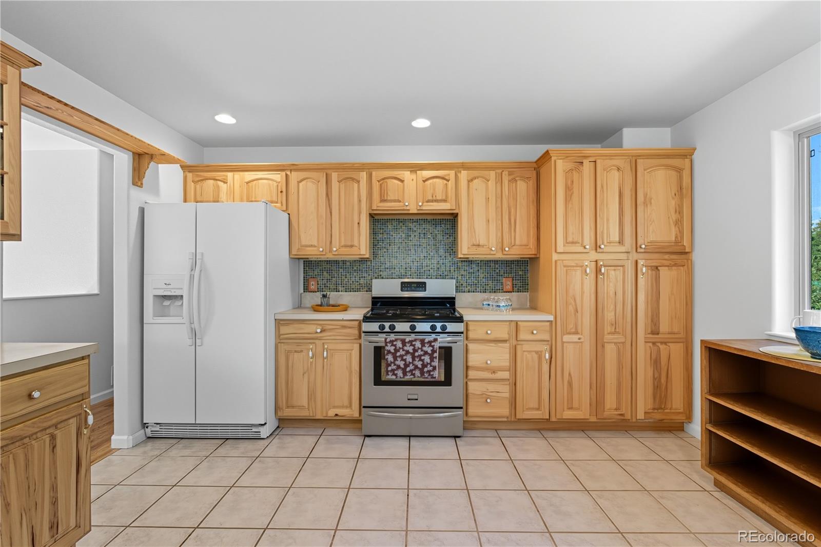 4 Gap Road Black Hawk, CO 80422 - Photo 12 of 43 a kitchen with a refrigerator a stove top oven and cabinets